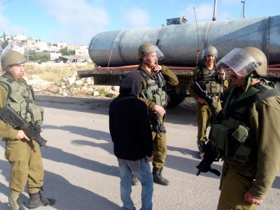 Child being detained by military on the way to school, 16th May